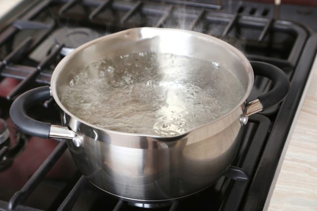 boiling water in a metal pot